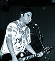 Nick Santini playing guitar and singing.